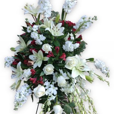 The Heart of Red & White Standing Spray is an elegant floral arrangement that truly expresses heartfelt condolences at the funeral or memorial service of a loved one.