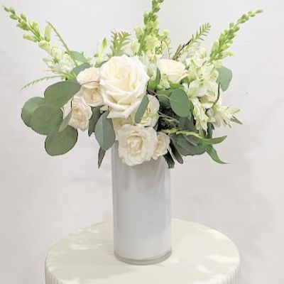 A bouquet of white and green is always an elegant choice! Pure white blooms with silvery eucalyptus make this classic bouquet unforgettable. Send it as a gift for any occasion! Size: Stems are clipped to 15” and arranged in a tight, raffia-tied bouquet Care: Included with the arrangement